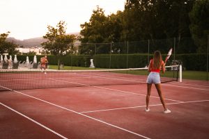 Couple playing tennis at the court