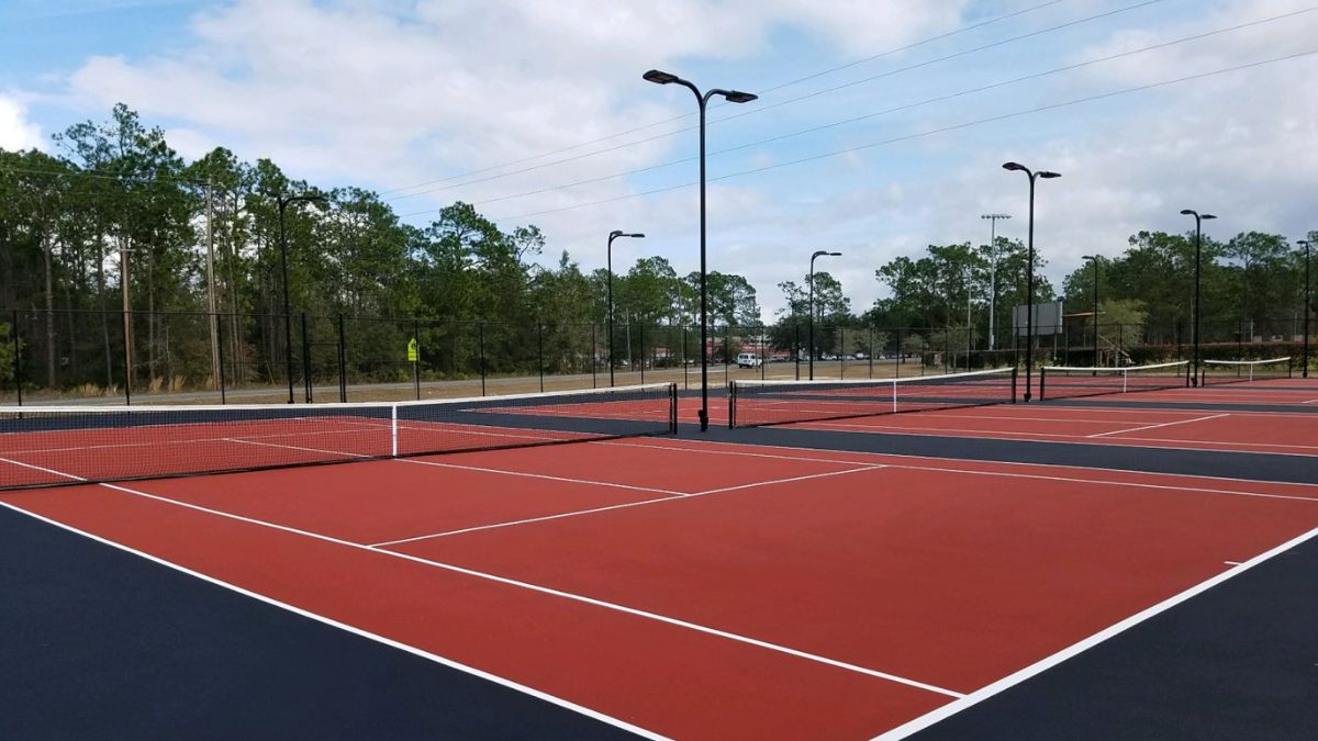 A Tennis Court With Net And Poles