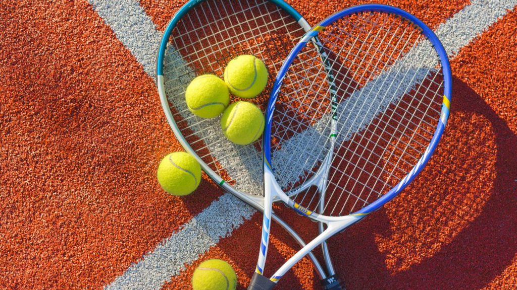 Tennis Rackets And Balls On Court
