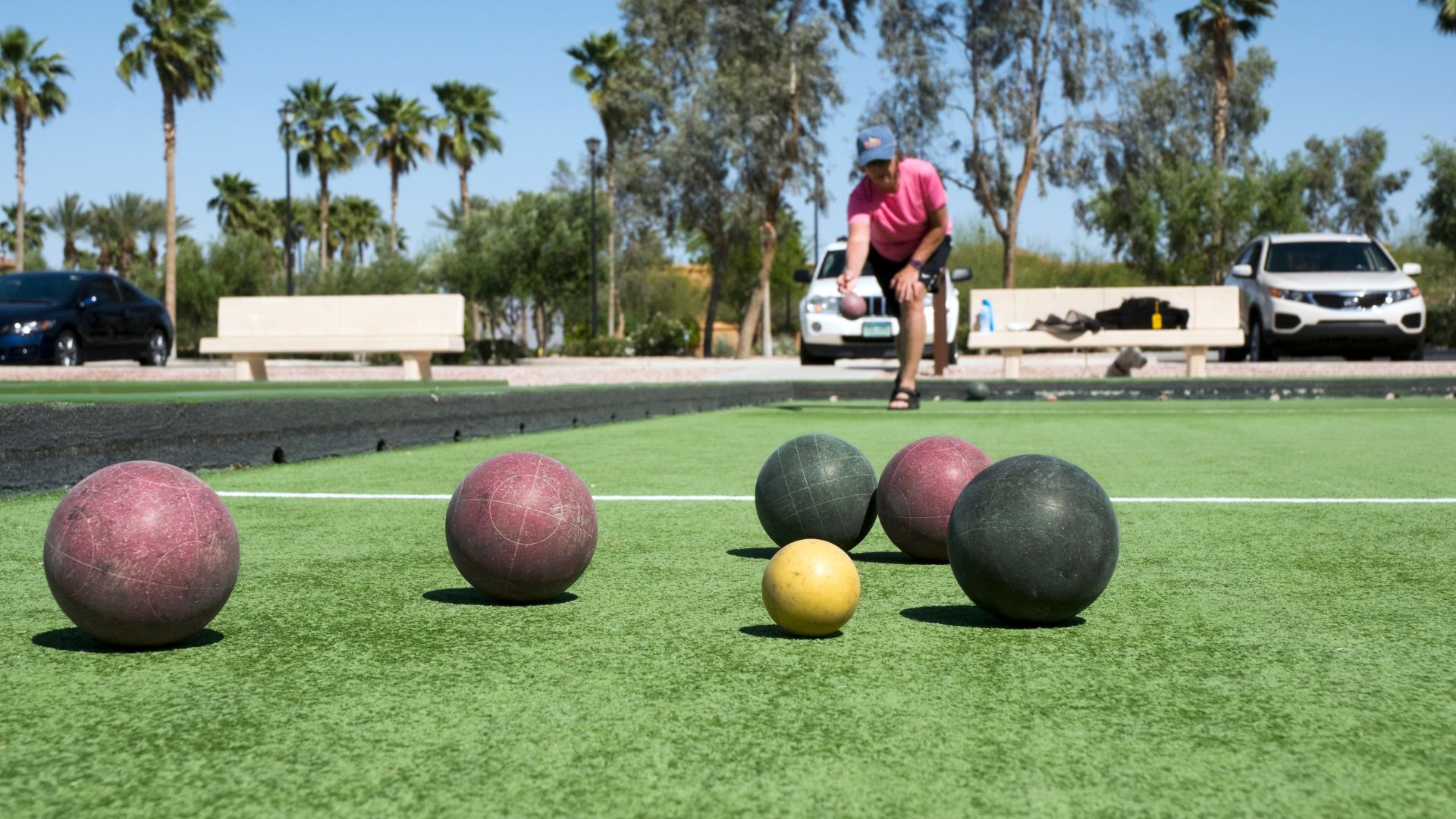 Person Playing Bocce Ball On Court