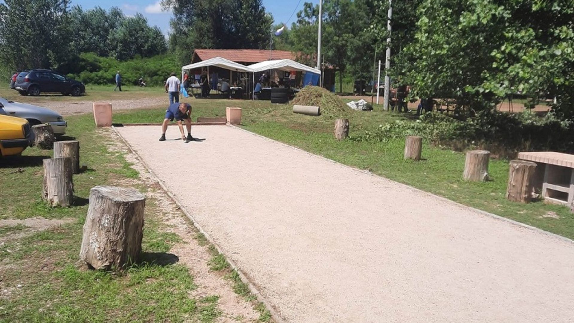 Person Playing Bocce Ball On Gravel Court